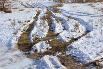 Road dirt in the snow in winter