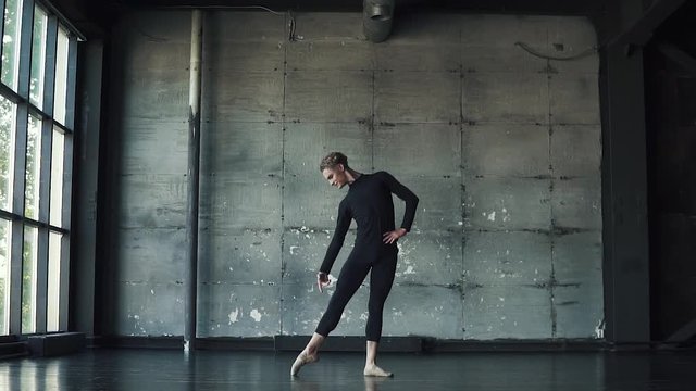 portrait of a male ballet dancer on a dark background. slow motion