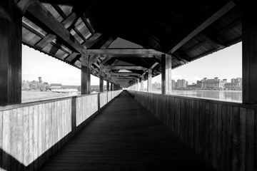 Obraz premium Wooden covered bridge by the river