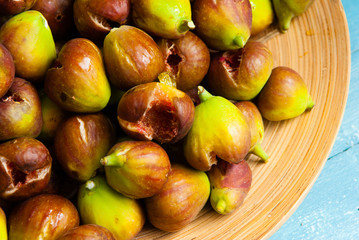 over ripe figs from bio garden, on blue wood table background