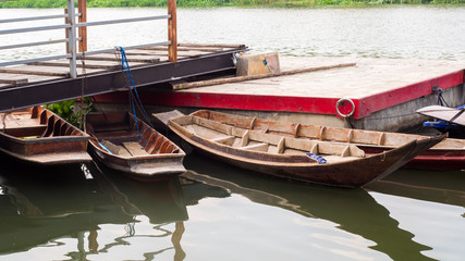 Fototapeta na wymiar Old wooden row boat on water