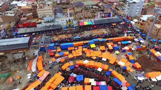 Oruro village carnival parade aerial view.  Colorful Bolivian folklore parade with Tinkus dancing and parading. Masterpiece of the Oral and Intangible Heritage of Humanity by Unesco.