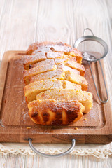 Pound cake, with icing sugar, sliced