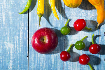 autumn vegetables with shadow on worn blue wood table background