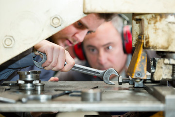 close-up apprentice holding a wrench