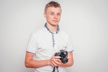 Young photographer with camera, isolated on white