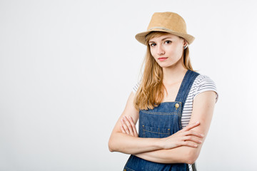 Beautiful young woman wearing a denim jeans, t-shirt and summer hat  summer hipster hat. Traveling style girl on white background with space for your text