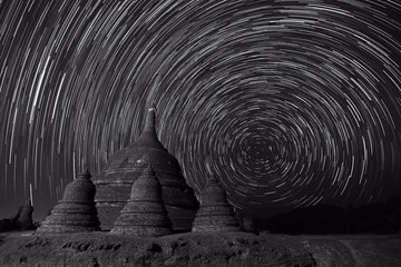 Black and white photography of long exposure image showing star trails over Ratanabon Paya in Mrauk-U, Myanmar 
