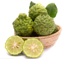 The kaffir lime leaves in the basket on a white background.