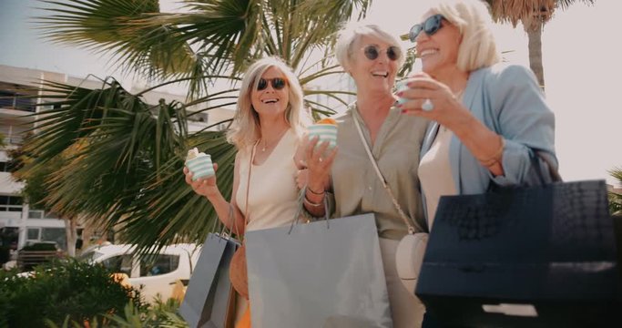 Mature women shopping and eating ice cream in the city