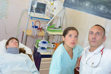 mid age male doctor with female patient