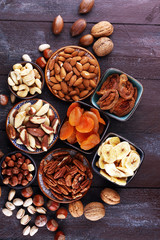 dried fruits and assorted nuts composition on rustic table