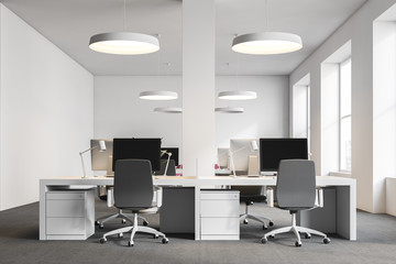 Computer tables in white office, front view