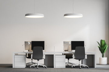 Computer tables in loft office, ceiling lamps