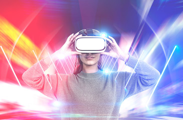 Serious young woman in vr glasses glowing wormhole