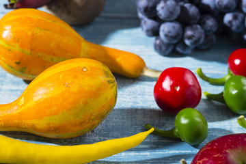 autumn vegetables with shadow on worn blue wood table background
