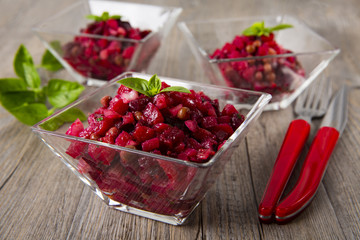 Salad from the beet. Vinegret is a traditional Russian salad made from beets and vegetables. Three bowls with salad.