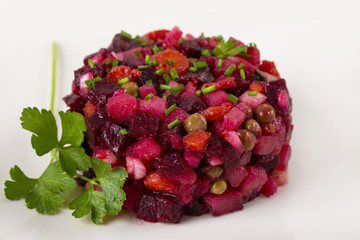 Salad from the beet. Vinegret is a traditional Russian salad made from beets and vegetables. . The background is white. Copy space.
