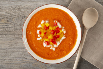 Soup gazpacho. Italian cuisine. Plate with soup in a white plate on a rustic background. Top Vieux. Copyspace.