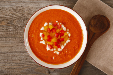 Soup gazpacho. Italian cuisine. Plate with soup in a white plate on a rustic background. Top Vieux. Copyspace.
