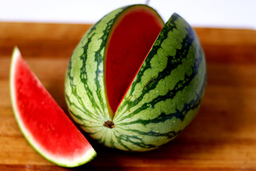 Whole watermelon & slice isolated on wooden background 2