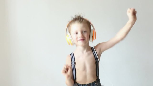 young boy dance and listen music with headphone