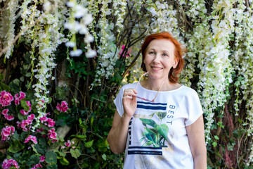 elderly woman with red hair on the street