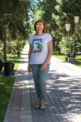 Fototapeta premium elderly woman with red hair on the street