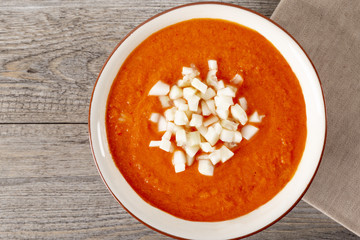 Soup gazpachos with shrimps, Italian cuisine. Plate with soup in a white plate on a rustic background. Top of the Vieux. Copyspace.