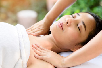 Fototapeta na wymiar Sholder massage with young Asian woman