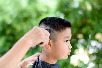Young boy get hair cut