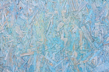 Colorful ( blue and yellow) painted OSB board as background, texture