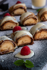 banan pancake sushi dessert with dip and chocolate syrup