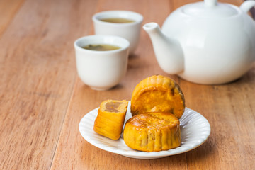close-up of moon cake on wooden table, chinese mid-autumn festival