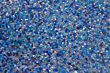 Colorful (blue, green, white and purple) stone mosaic tiles on the wall as background or texture