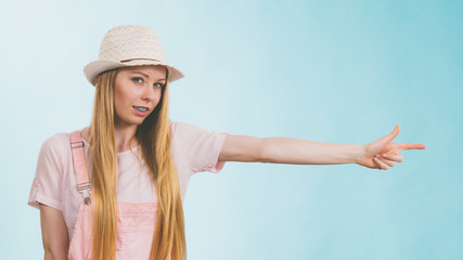 Woman wearing summer outfit pointing