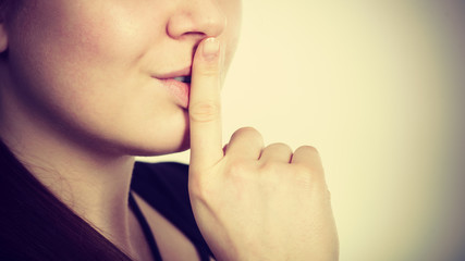 Woman showing silence gesture with finger