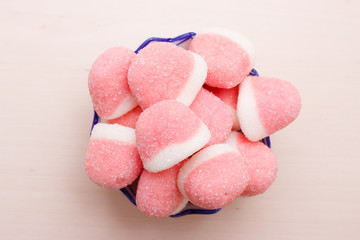 Pink jellies or marshmallows with sugar in bowl