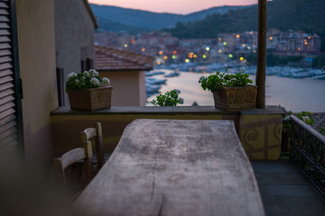 Summer evening on the vintage terrace above the port