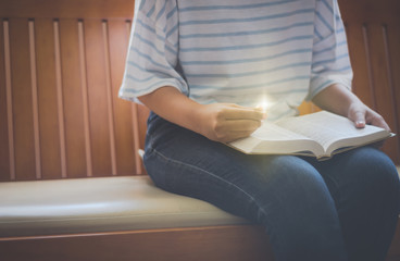 Young women reading the Holy Bible.