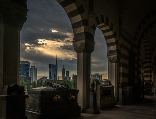 milano skyline view in a cloudy day with epic sky from the monumental cemetery