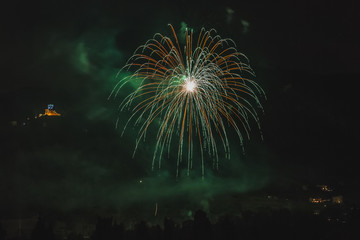 Green fireworks on the feast of the patron saint of the city whose church is visible in the background, Vittorio Veneto, Italy