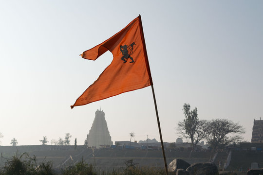 An orange flag with Virupaksha temple in Hampi, India
