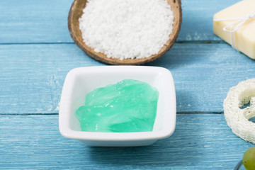 beauty product samples from grape seed ingredient, blue wooden table background, soft light