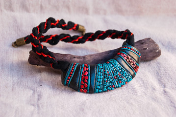 Handmade jewelry. Traditional tibetan turquoise, black and red bib necklace from polymer clay.