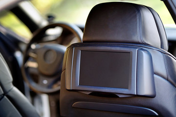 Car inside. Interior of prestige luxury modern car. Display for back seats passenger with copy...