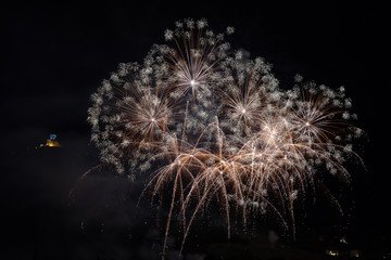 Wonderful fireworks on the feast of the patron saint of the city whose church is visible in the background, Vittorio Veneto, Italy