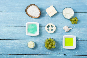 beauty product samples from grape seed ingredient, blue wooden table background, soft light