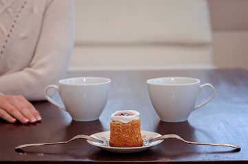 Waiting for someone in a caf'e on a table for 2: Runeberg's cake or tart is a Finnish traditional dessert and pastry