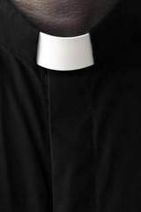 Priest on a dark background. Close-up. - obrazy, fototapety, plakaty